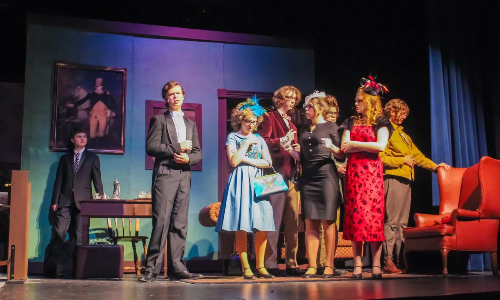 Actors in Brentwood High's Clue production stand onstage